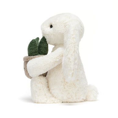 Lapin crème avec plante