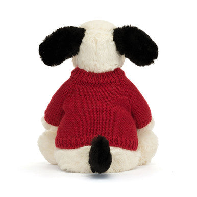 Chiot timide noir et crème avec pull rouge personnalisé